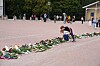 To barn legger ned blomster på slottsplassen.
